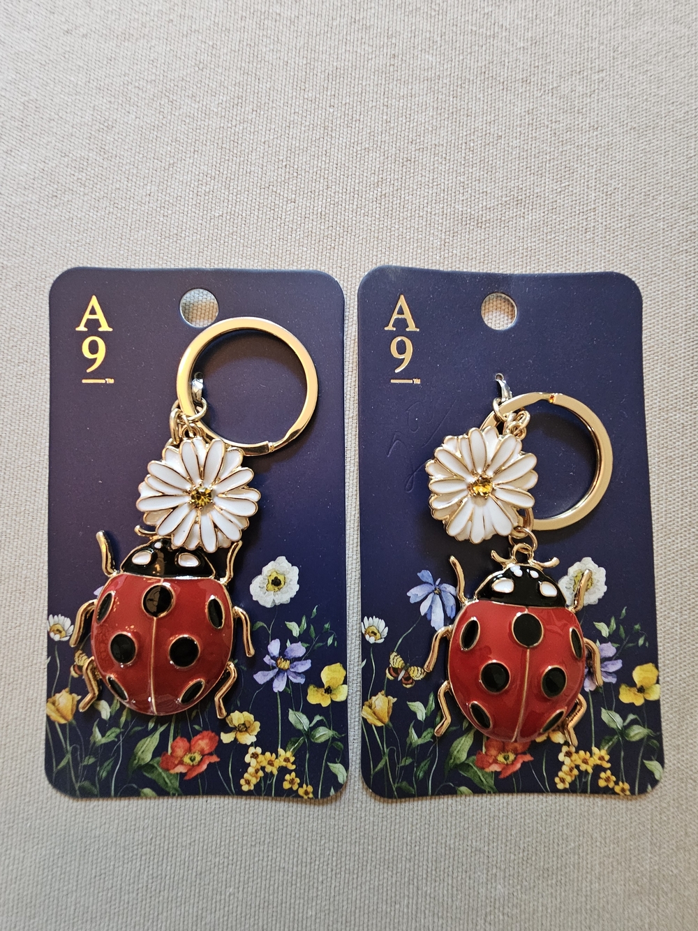 NWT Lot of Two Avenue 9 Red Ladybug & White Daisy Keychain with Gold Hardware